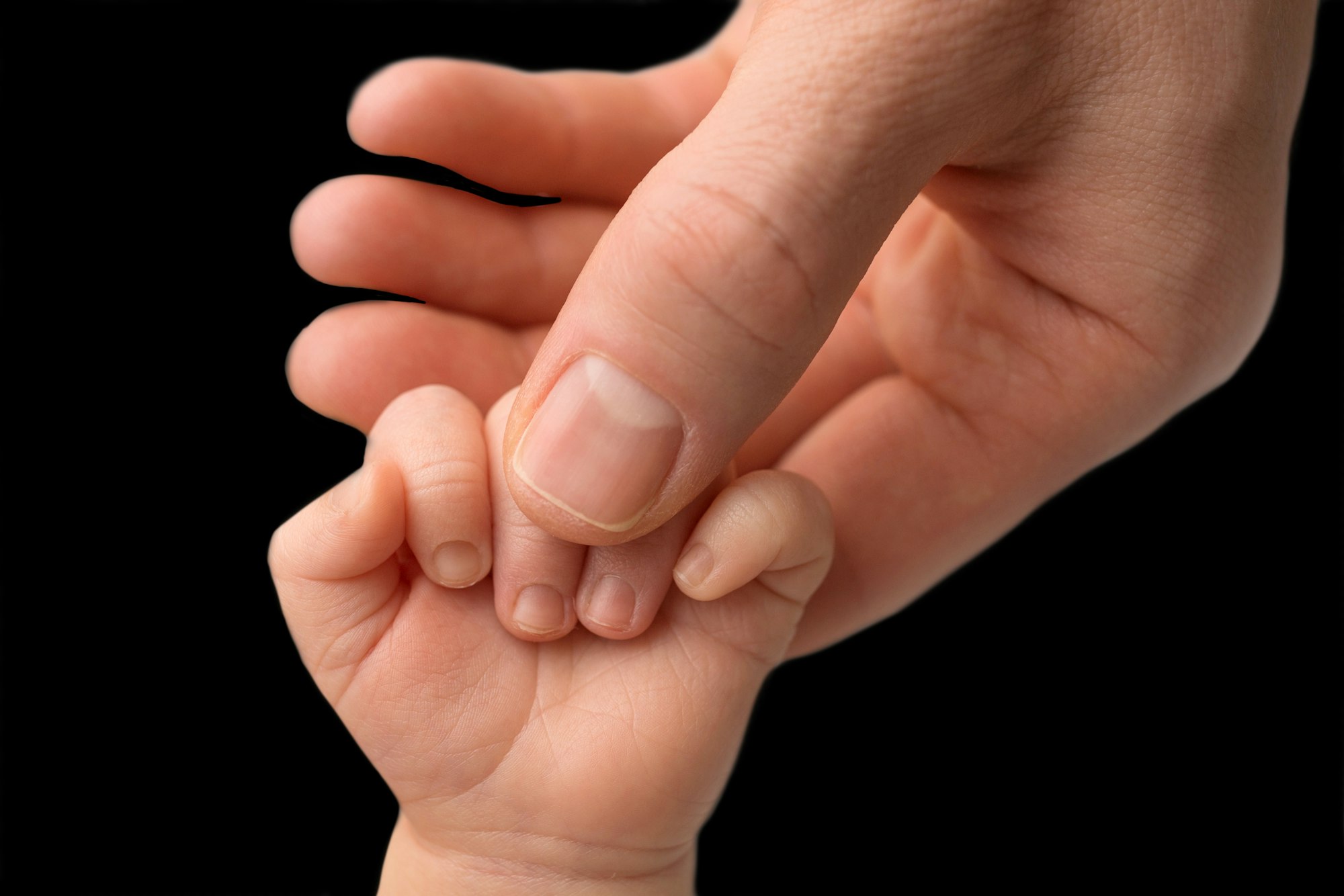 Father holding newborn baby's fingersnewborn . Hand of a newborn baby.