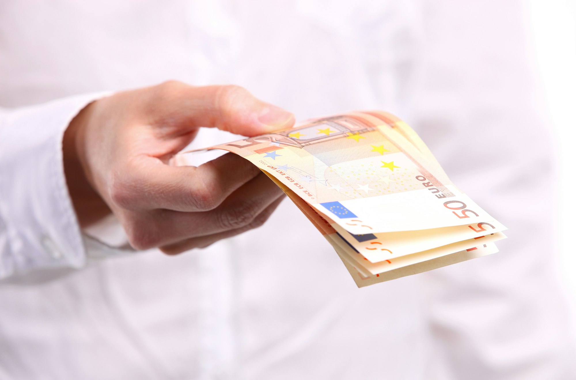 Female hand holding fifty euro banknotes