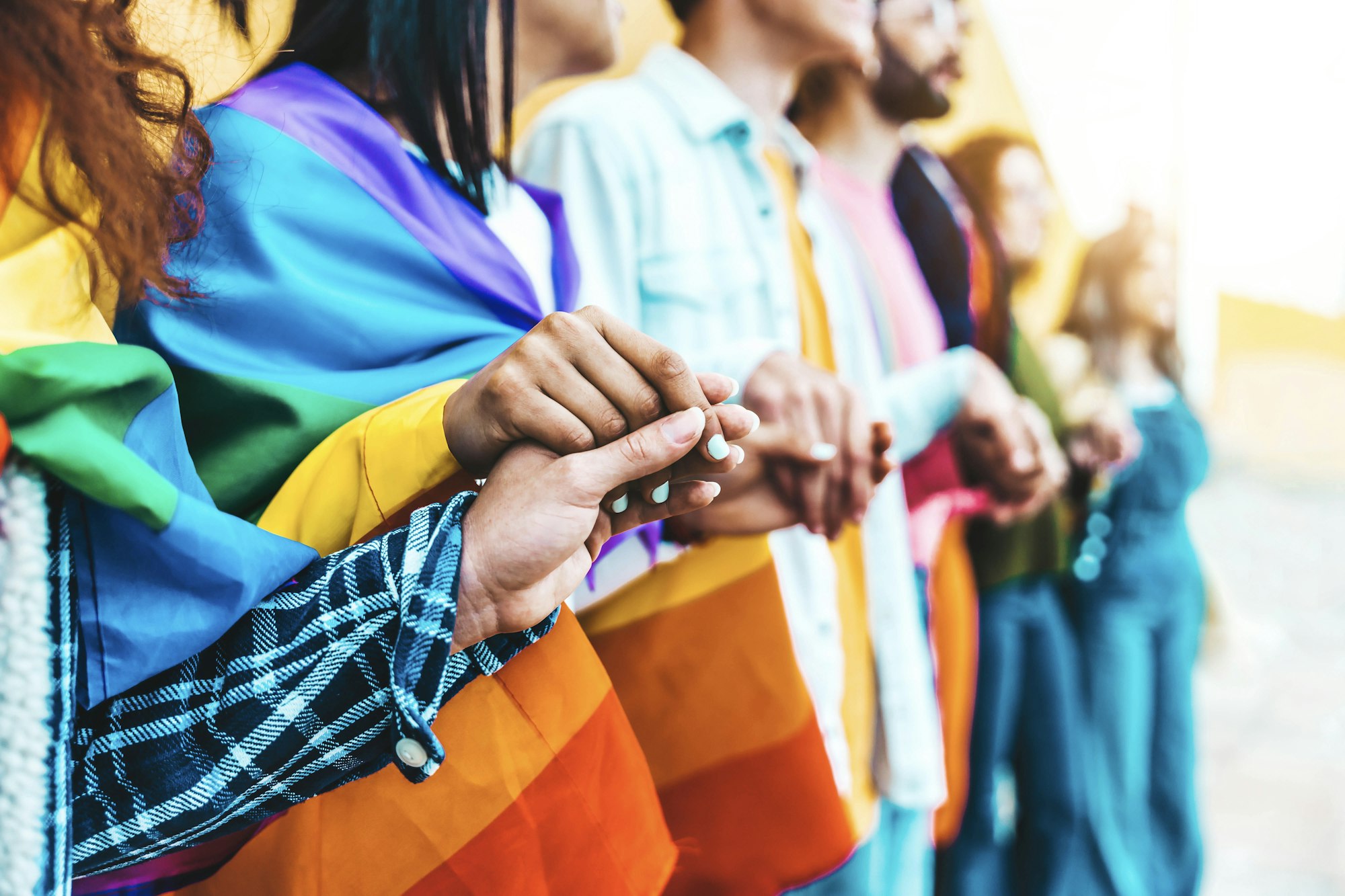 Group of lgbt people holding hands outside