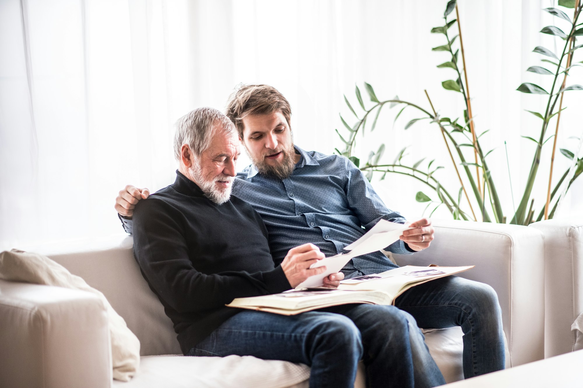 Hipster son and his senior father at home.